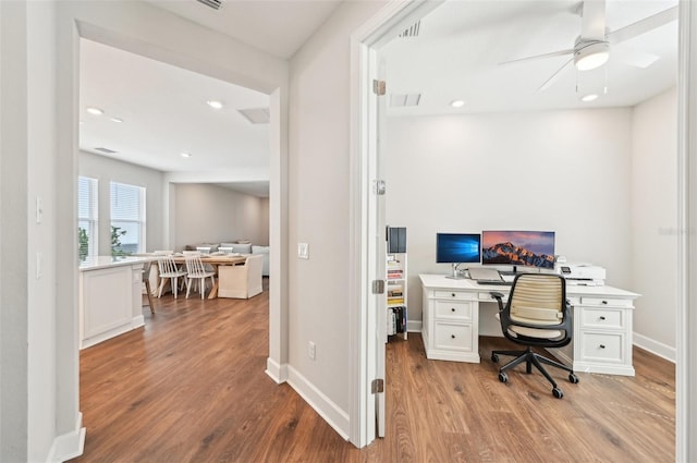 office featuring recessed lighting, visible vents, baseboards, and wood finished floors