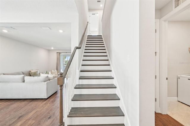 staircase with recessed lighting, visible vents, and wood finished floors