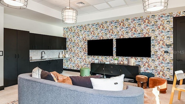 living area featuring visible vents and a raised ceiling