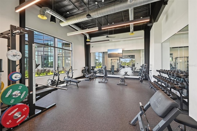 exercise room with a towering ceiling