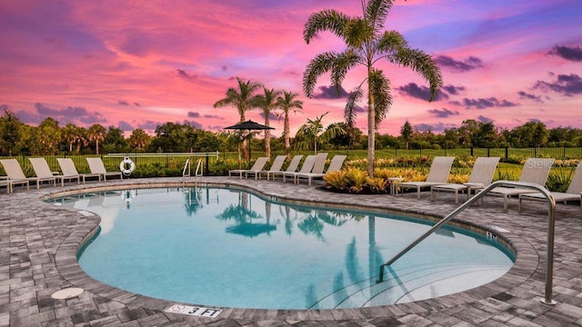 pool featuring a patio area and fence