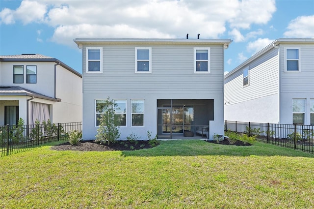 back of property featuring stucco siding, a lawn, a fenced backyard, and a sunroom