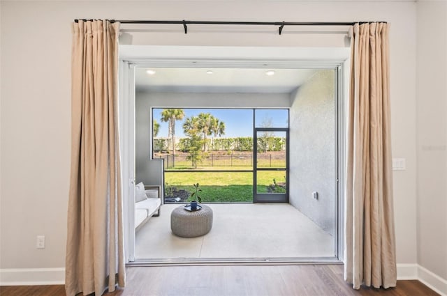 interior space featuring wood finished floors and baseboards