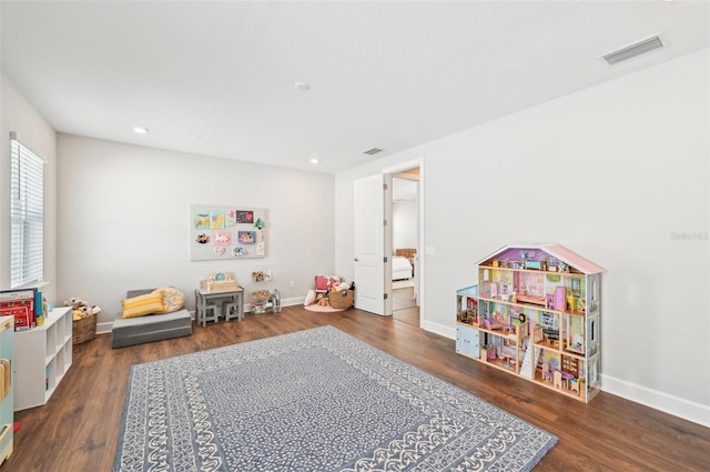 recreation room with baseboards and wood finished floors