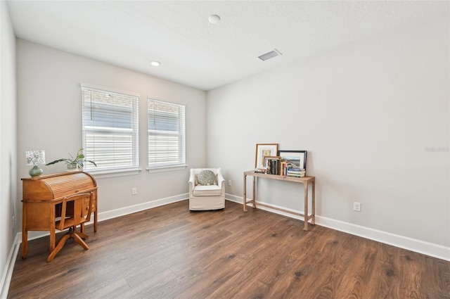 sitting room featuring visible vents, wood finished floors, and baseboards