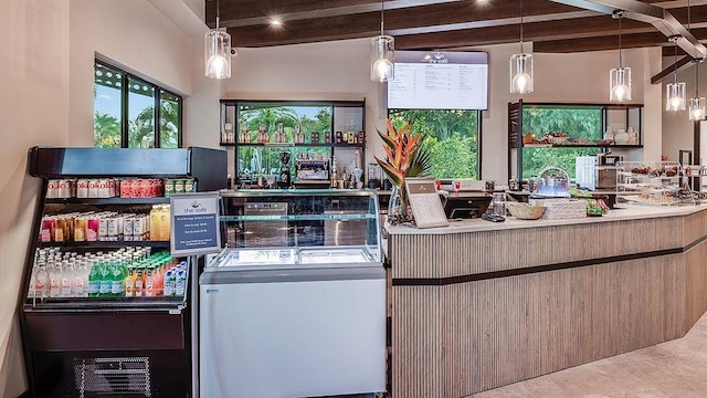 kitchen with beam ceiling and pendant lighting