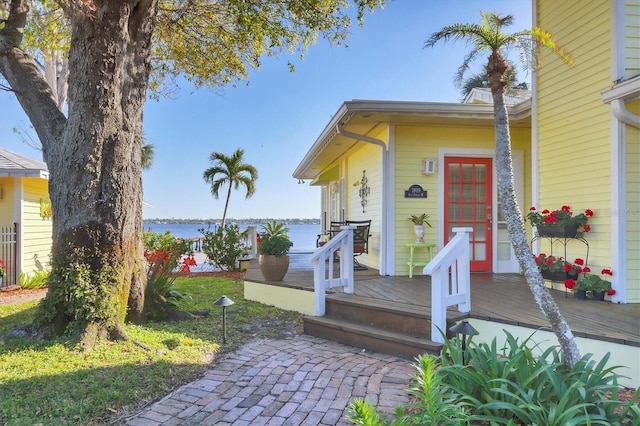 entrance to property with a deck with water view