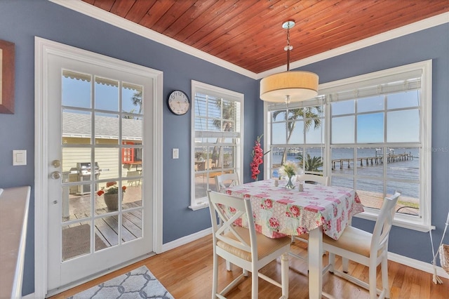 dining room featuring crown molding, wood finished floors, baseboards, and wooden ceiling