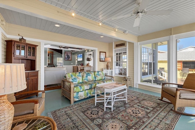 living room with rail lighting, wooden ceiling, a ceiling fan, and a sunroom