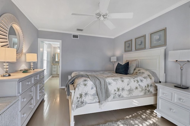 bedroom with visible vents, connected bathroom, baseboards, ornamental molding, and wood finished floors