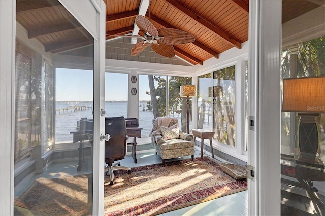 sunroom / solarium featuring a water view, a ceiling fan, wooden ceiling, and vaulted ceiling with beams