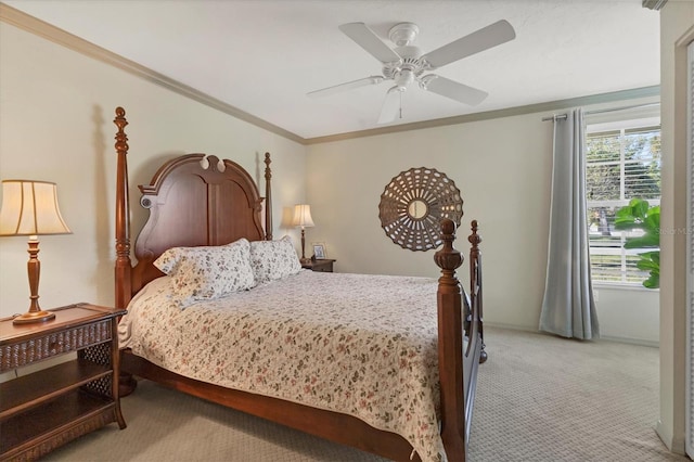 carpeted bedroom featuring ceiling fan and ornamental molding