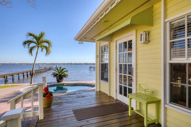 exterior space featuring a jacuzzi and a water view