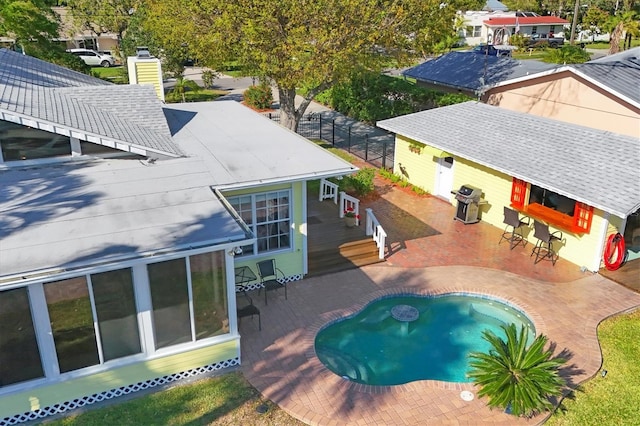 pool with a patio and area for grilling