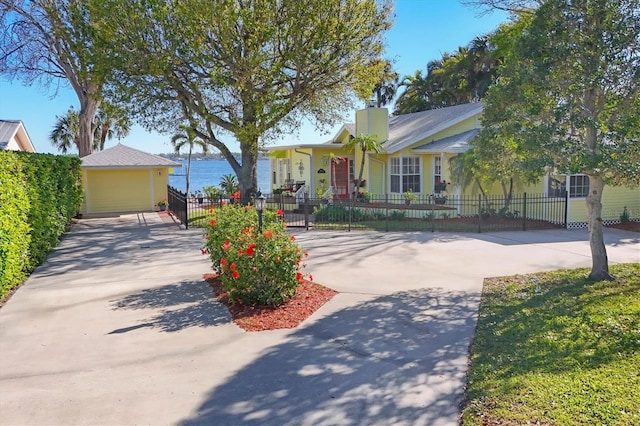 view of front of house with a fenced front yard and a chimney