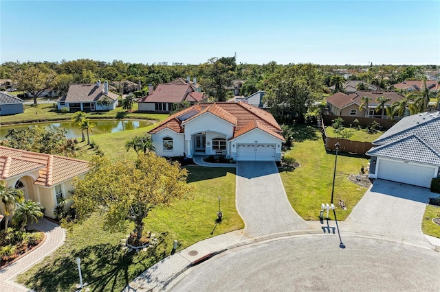 drone / aerial view featuring a residential view and a water view