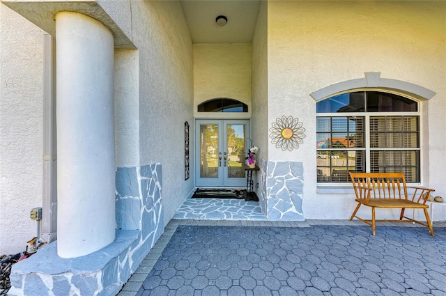 entrance to property with french doors and stucco siding