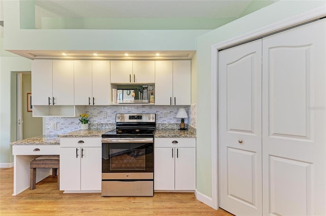 kitchen featuring decorative backsplash, appliances with stainless steel finishes, light wood-style floors, and light stone countertops