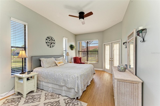 bedroom featuring french doors, baseboards, light wood-style floors, and ceiling fan