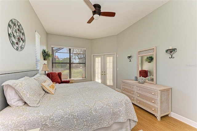 bedroom with ceiling fan, french doors, light wood-type flooring, and baseboards