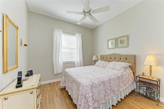 bedroom with light wood finished floors, ceiling fan, and baseboards