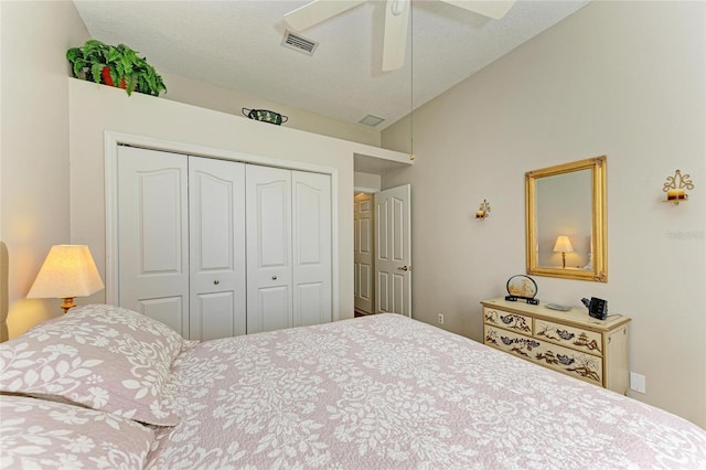 bedroom with a closet, visible vents, ceiling fan, and vaulted ceiling