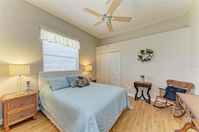 bedroom with a closet, lofted ceiling, baseboards, and light wood-style flooring