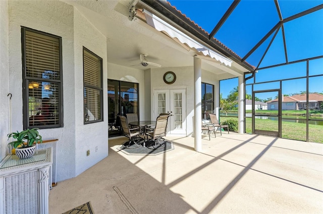 view of patio / terrace featuring glass enclosure, french doors, and ceiling fan