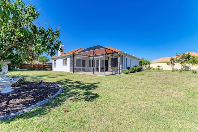 view of yard with a lanai and fence