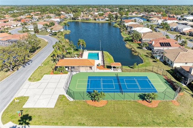 drone / aerial view with a residential view and a water view