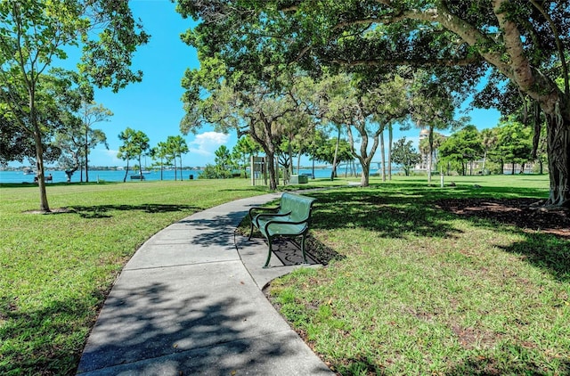 view of property's community with a yard and a water view