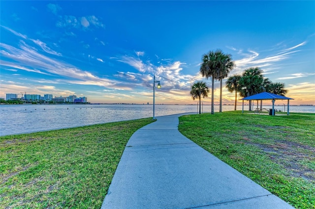 surrounding community featuring a gazebo, a lawn, a view of city, and a water view