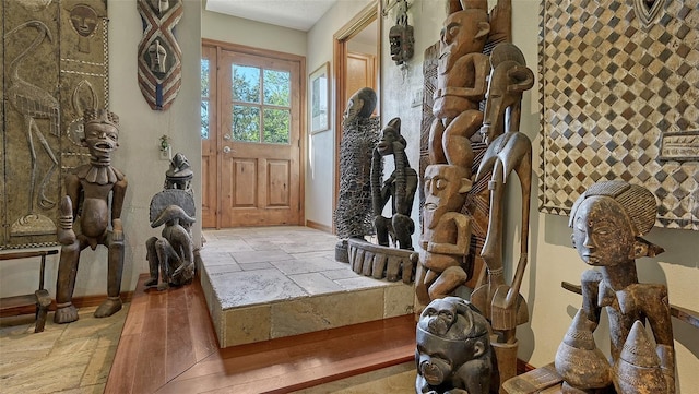 entryway featuring stone tile floors and baseboards