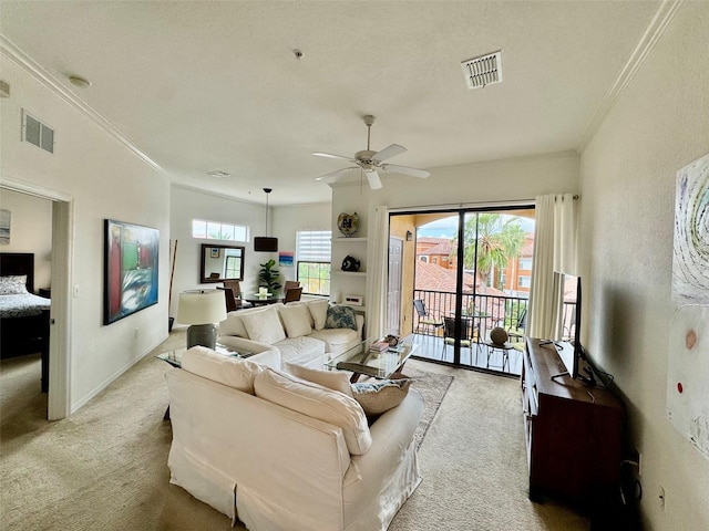 carpeted living room with visible vents, baseboards, ceiling fan, and ornamental molding