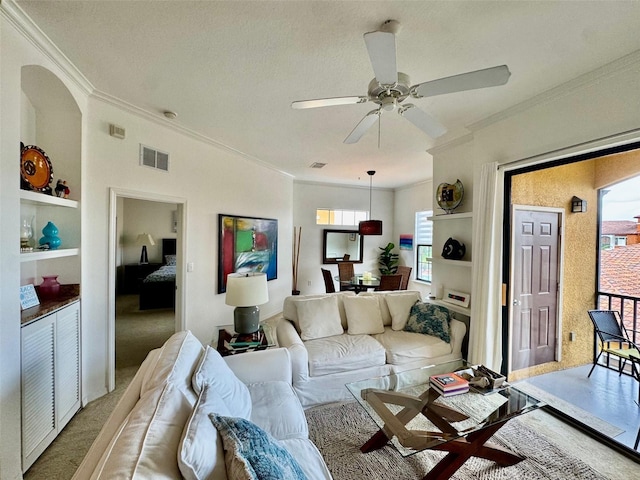 living area featuring crown molding, light colored carpet, and visible vents