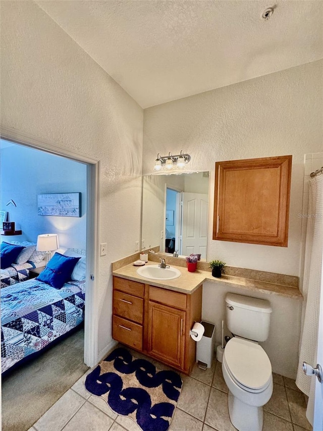 full bathroom featuring ensuite bath, vanity, a textured wall, tile patterned floors, and a textured ceiling