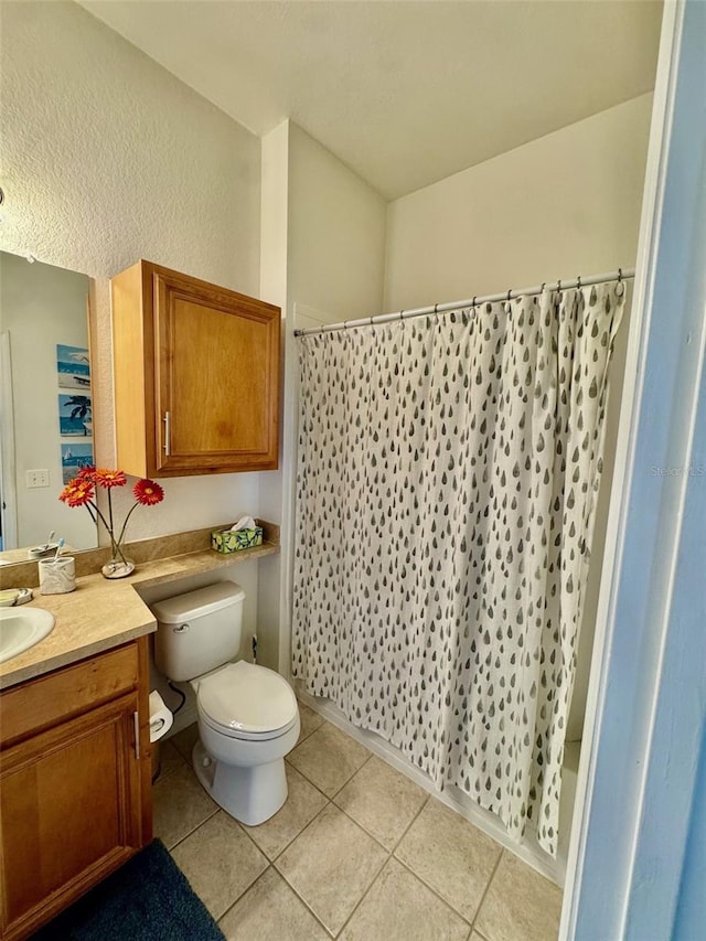 bathroom featuring vanity, curtained shower, toilet, and tile patterned flooring