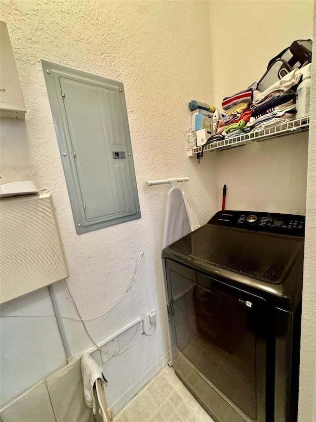 laundry room featuring electric panel, washer / clothes dryer, and laundry area