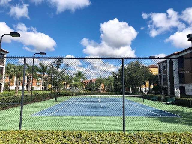 view of tennis court with fence