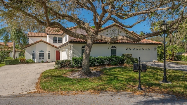 mediterranean / spanish-style house featuring a garage, a tile roof, driveway, and stucco siding