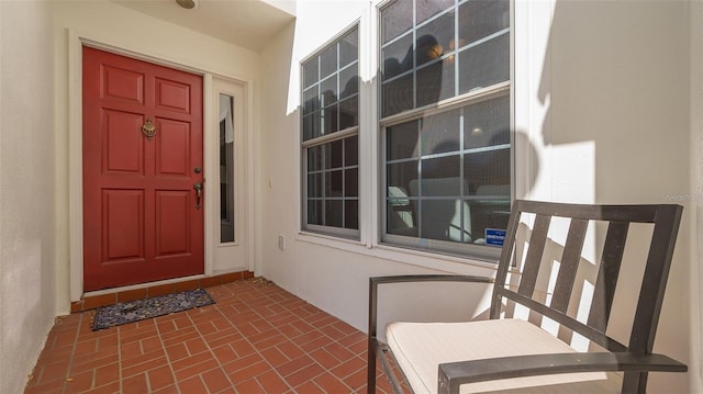 view of exterior entry with stucco siding