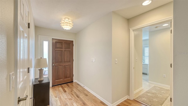 foyer with recessed lighting, baseboards, and light wood-type flooring