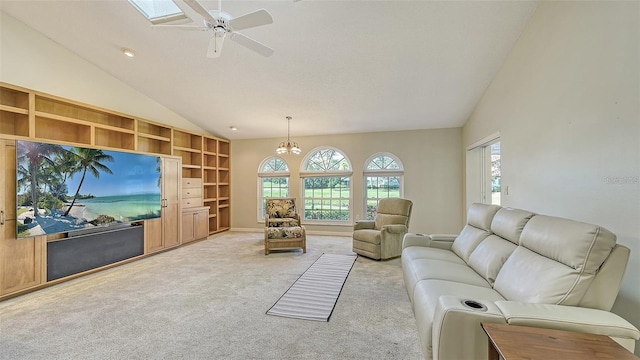 living room featuring carpet floors, ceiling fan with notable chandelier, built in shelves, and vaulted ceiling