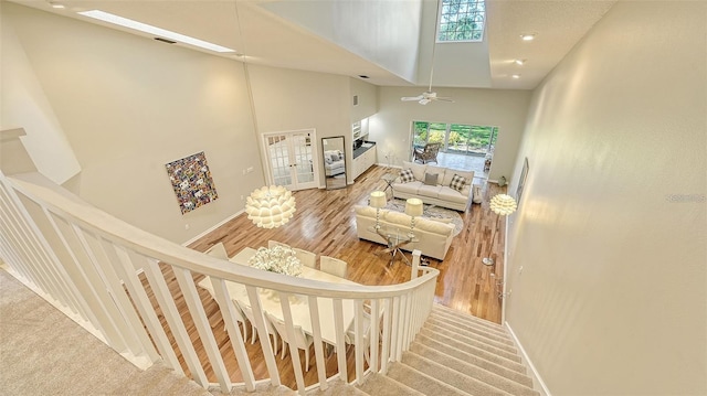 stairway featuring visible vents, carpet flooring, french doors, and a high ceiling