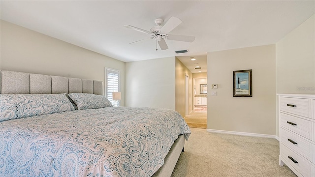 bedroom with baseboards, light carpet, visible vents, and ceiling fan