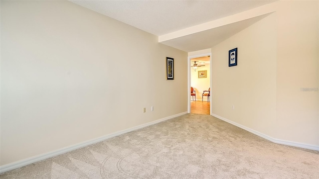 unfurnished room with baseboards, carpet floors, and a textured ceiling