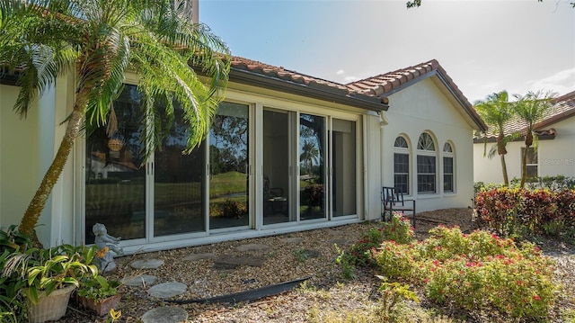 view of home's exterior with stucco siding and a tiled roof