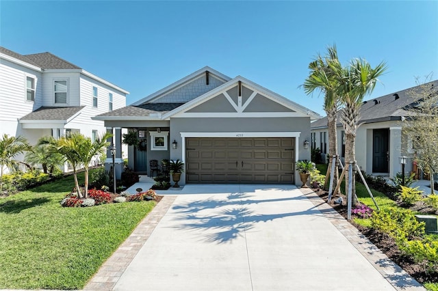 view of front of home featuring stucco siding, driveway, an attached garage, and a front lawn