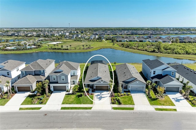 birds eye view of property featuring a residential view and a water view