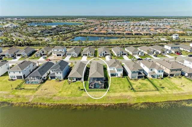 drone / aerial view with a residential view and a water view